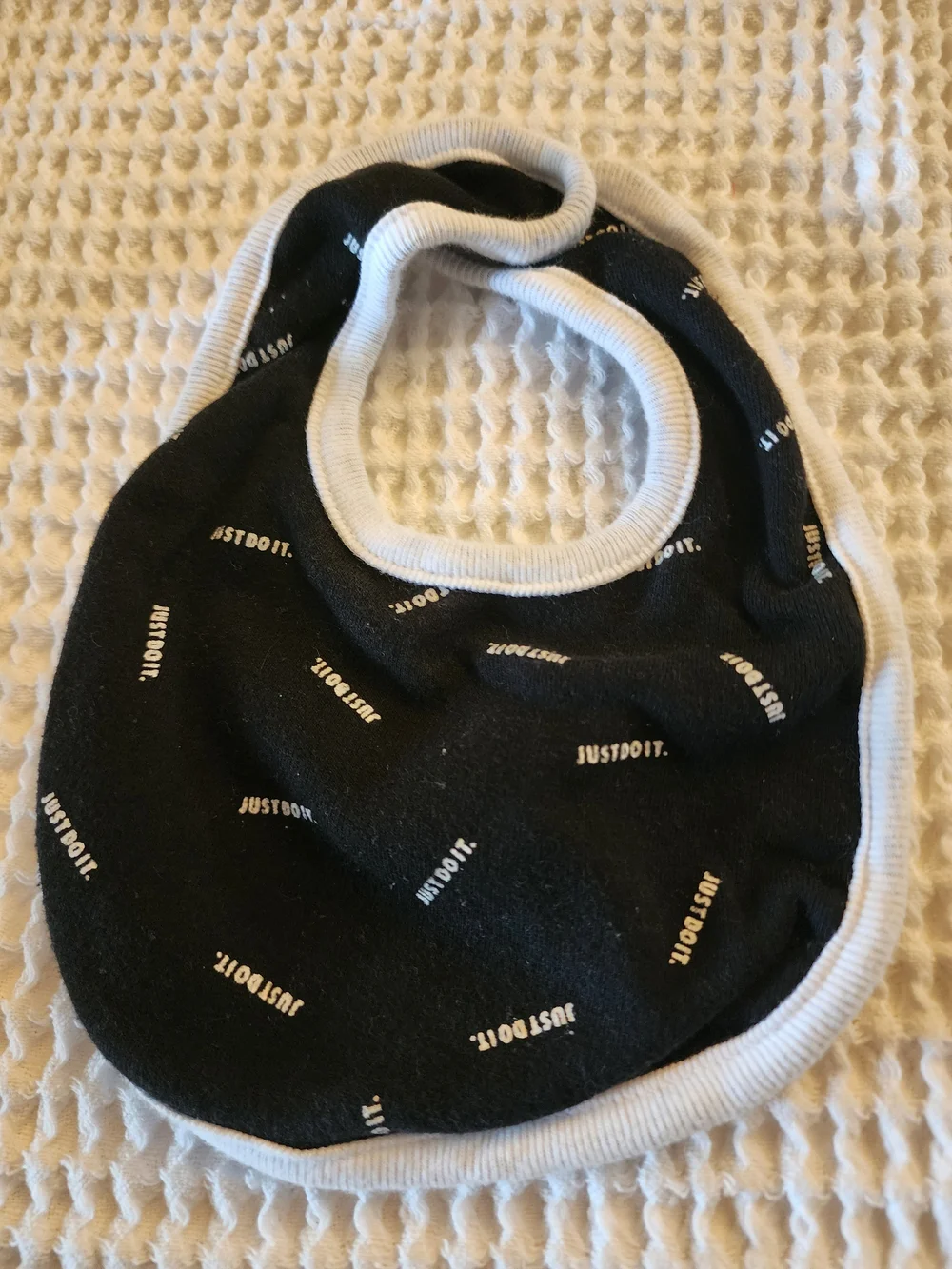 Nike Black Baby Bib with White Trim and 'Just Do It.' Print